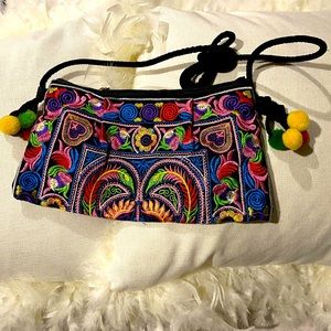 Women’s vibrant color crossbody bag with pom poms